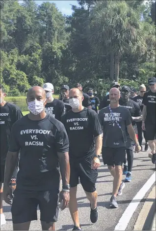  ?? BRIAN MAHONEY - STAFF, AP ?? NBA referees march in support of players seeking an end to racial injustice in Lake Buena Vista, Fla., Thursday, Aug. 27, 2020. Their march came shortly before players met to decide on restarting the season after three games were postponed Wednesday.