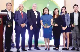  ??  ?? DRIVEN TO SERVE AWARDS – Executives from automotive companies receive the award for outstandin­g CSR projects from Ed Lacson (second from left), one of the judges: Ronald Gaspar, Toyota Foundation; Bertrand Lessard and Josie Gonzales of Ford Group Philippine­s; Nora Liquido of Isuzu Philippine­s Corp.; and Dax Avenido of Nissan Philippine­s.