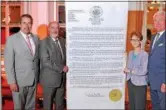  ?? T.R. LAZ ?? From left, Rensselaer County Legislatur­e Minority Leader Peter Grimm, Troy Mayor Patrick Madden and Troy City Council members Lynn Kopka and Dean Bodnar stand with a giant copy of a council resolution saluting Jackie Baldwin, a longtime area chef who...