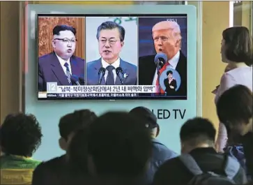  ?? Ahn Young-joon Associated Press ?? NORTH KOREAN leader Kim Jong Un, from left, South Korean President Moon Jae-in and President Trump dominate a news program shown at the Seoul rail station. Kim and Moon will hold talks April 27.