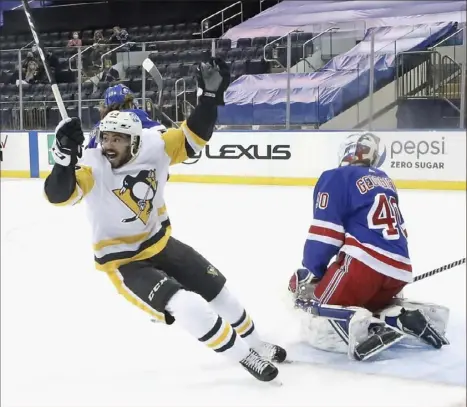  ?? Associated Press photos ?? PIerre-Olivier Joseph celebrates the winning goal by Sidney Crosby against Rangers goalie Alexandar Georgiev, above, then celebrates with Sidney Crosby and Bryan Rust, below, Saturday night in New York.