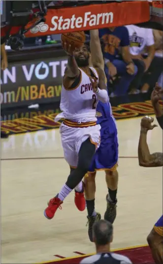  ?? TIM PHILLIS — THE NEWS-HERALD ?? Kyrie Irving drives to the basket during the first half of Game 4 of the NBA Finals against the Warriors on June 9.