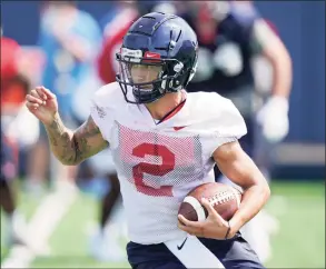  ?? Rogelio V. Solis / Associated Press ?? Ole Miss quarterbac­k Matt Corral runs with the ball during practice on Monday.
