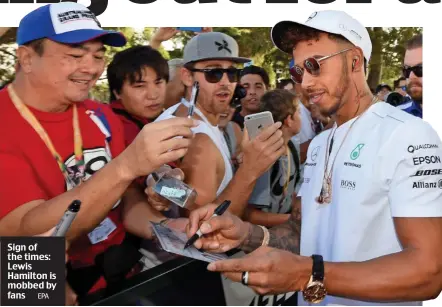  ?? EPA ?? Sign of the times: Lewis Hamilton is mobbed by fans