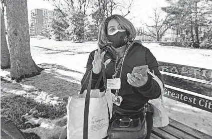  ?? KENNETH K. LAM/BALTIMORE SUN ?? Karen Kennedy, waiting on a bus after work, will be getting the COVID-19 vaccine from LifeBridge Health where she works as a copy center operator.