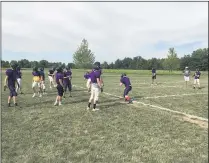  ?? ADAM SCHABEL — THE MORNING JOURNAL ?? Keystone quarterbac­ks and receivers run through a drill during practice Aug. 12.