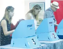  ?? (Marc Israel Sellem/The Jerusalem Post) ?? PARTY MEMBERS vote in a primary, a system that Likud MK David Amsalem said gives an unfair advantage to those who have financial means.