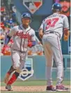  ?? AP PHOTO/JIM MONE ?? The Atlanta Braves’ Ozzie Albies, left, rounds third base and passes coach Ron Washington as he heads home on a solo home run off Minnesota Twins pitcher Martin Perez in the sixth inning Wednesday. Albies also homered in the first inning.