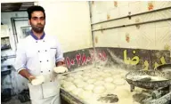  ??  ?? Iranian baker Farzad Rabiei, 30, poses with Barbari bread dough