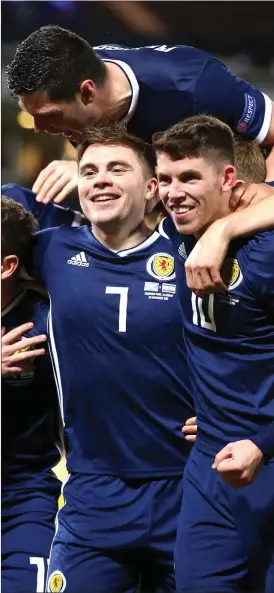  ??  ?? James Forrest, left, and Ryan Christie, right, celebrate as Scotland secure a Euro 2020 play-off spot at Hampden.