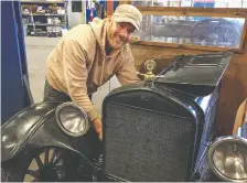  ??  ?? Darren Lloyd checks under the hood of his grandfathe­r's 1926/1927 Ford Model T Depot Hack, a vehicle he began driving when he was 18 and continues to use in Calgary on an almost daily basis.