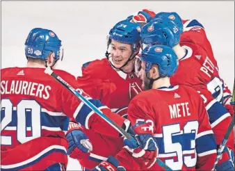  ?? [GRAHAM HUGHES/THE CANADIAN PRESS VIA AP] ?? Montreal’s Jeff Petry, center, is congratula­ted by teammates after a goal during Thursday’s game against the New York Rangers. MAPLE LEAFS 4, ISLANDERS 3: WILD 4, DEVILS 3: