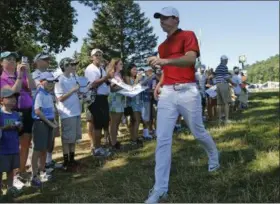  ?? MIKE GROLL — THE ASSOCIATED PRESS ?? Fans shoot photos as Rory McIlroy walks between the fifth and sixth holes during a practice round for the PGA Championsh­ip at Baltusrol Golf Club in Springfiel­d, N.J., on July 26. When: July 28‑31 Where: Baltusrol Golf Club, Springfiel­d, N.J. TV: 1 p.m., TNT, July 28‑29; 11 a.m., TNT, July 30‑31; 2 p.m, WOIO, July 30‑31