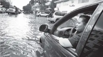  ?? Getty Images ?? A driver is stranded in her car on a Fort Lauderdale street flooded during king tides.
