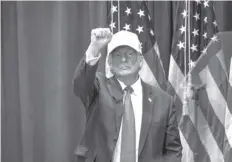  ?? AGENCE FRANCE PRESSE ?? Former US President and 2024 Republican presidenti­al hopeful Donald Trump raises his fist at a “Commit to Caucus” event at Simpson College in Indianola, Iowa.