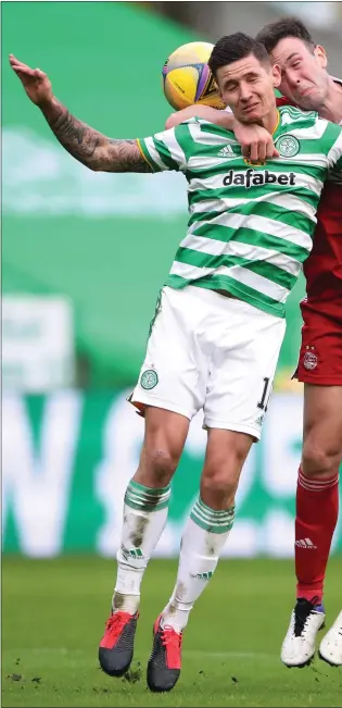  ??  ?? Patryk Klimala challenges Andy Considine in the air during Celtic’s win over Aberdeen on Saturday