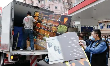  ?? Photograph: Tyrone Siu/Reuters ?? Police collect an exhibition board from the June 4th Museum, which commemorat­es the 1989 Tiananmen Square crackdown.