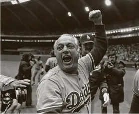  ?? Grimshaw / Associated Press ?? Tommy Lasorda celebrates after the Dodgers won the 1981 NL pennant. Lasorda, who managed the team for 21 years, winning twoWorld Series, died Thursday.