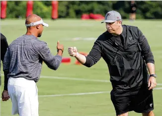  ?? CURTIS COMPTON/AJC 2021 ?? Coach Arthur Smith (right) says general manager Terry Fontenot has become a great friend in just a few months’ time. “Terry and I have been working hand-in-hand since January.”