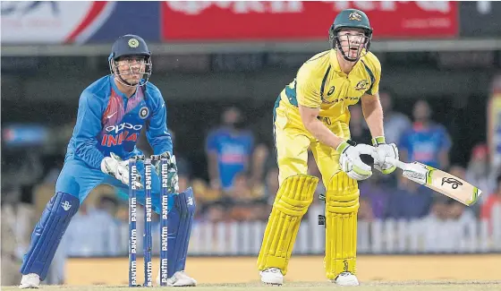  ??  ?? Australia’s Tim Paine, right, plays a shot during a T20 match against India last month.