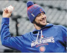  ?? DAVID J. PHILLIP/THE ASSOCIATED PRESS ?? Chicago Cubs third baseman Kris Bryant warms up during Monday’s practice in Cleveland.