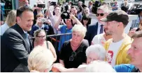  ??  ?? ABOVE: Taoiseach Leo Varadkar (left) is welcomed to the Museum of Orange Heritage in Belfast by the Grand Master of the Orange Lodge, Edward Stevenson
LEFT: The Taoiseach is greeted by members of the public following a visit to the museum. Photos: PA...