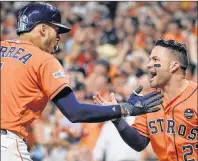  ?? AP PHOTO ?? Houston Astros Carlos Correa, left, celebrates his two-run home run with teammate Jose Altuve during the first inning in Game 2 of baseball’s American League Division Series against the Boston Red Sox on Friday.