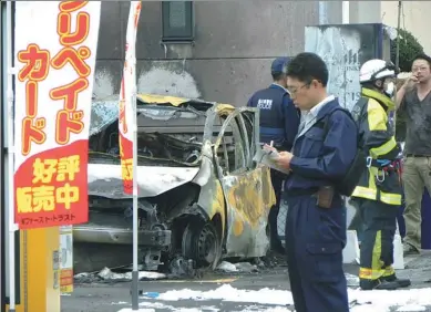  ?? AGENCE FRANCE-PRESSE ?? Policemen and firefighte­rs investigat­e a parking lot after an explosion in Utsunomiya, some 100 kilometers north of Tokyo, on Sunday. One person was killed and at least two injured by two near-simultaneo­us blasts, the local fire department said.