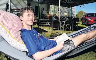  ?? PHOTOS: GREGOR RICHARDSON ?? Lying back . . . Chilling out in a hammock at the family crib in Karitane is Paddy Borthwick (17) of Dunedin.