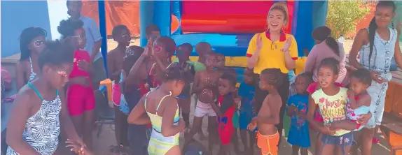  ?? Photo: Contribute­d ?? For the cause… Eagles Pizza HR and marketing head Jaimeelou Motoomull with children from the Orlindi Orphanage Home in Katutura.