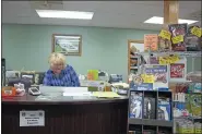  ?? SARAH DONKIN - THE ASSOCIATED PRESS ?? Darlene Miser works behind the counter of MM Feed Supply, in Pleasant City, Ohio, on Oct. 30. The feed supply store added broadband about five years ago to meet business demands. While the addition helped in some ways, speeds have slowed. After spending $30,000 to date for internet, Miser said they are unsure what the future holds when their contract ends.