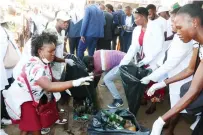  ?? ?? People pick up litter during a clean-up campaign with First Lady Dr Auxillia Mnangagwa in Harare yesterday