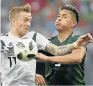  ??  ?? Picture: JUAN MABROMATA/AFP PHOTO MY BALL: Germany forward Marco Reus, left, fights for possession with Mexico defender Carlos Salcedo during their Russia 2018 World Cup Group F football match at the Luzhniki Stadium in Moscow on Sunday