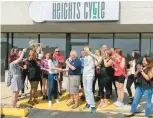  ?? BOB BONG/ DAILY SOUTHTOWN ?? Palos Heights Mayor Bob Straz welcomes Heights Cycle’s new owner, Megan Wenstrup, to the Palos Heights community during the grand opening event last month.