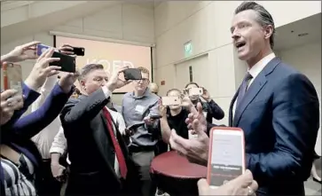  ?? Jeff Chiu Pool photos ?? DEMOCRATIC candidate Gavin Newsom speaks with reporters after the debate in San Francisco on Monday. It was the only debate between the two gubernator­ial candidates, and it wasn’t televised, airing on public radio.