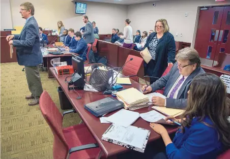  ?? EDDIE MOORE/JOURNAL ?? Public defenders and assistant district attorneys work in a 1st District Court courtroom in Santa Fe. Under the proposed Civil Rights Act, claims of constituti­onal rights deprivatio­ns would be filed in state District Courts around New Mexico.