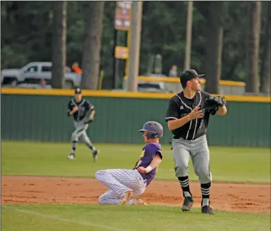  ?? Terrance Armstard/News-Times ?? Play at third: Junction City's Joe Lowe slides into third base as Smackover third baseman Nick Impson awaits the throw during their contest at Junction City earlier this season. The 8-3A District Tournament gets underway today in Smackover with two...