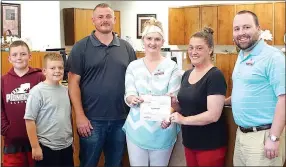  ?? Photo by Randy Moll ?? Carmen Arnold of Grand Savings Bank presented a $250 check to Kristi Reams of the Gentry Youth Organizati­on on Thursday to help purchase sports equipment. Jonathan Lemke and sons Elijah and Jeremiah of the GYO, and Mike Wilkins, vice president at the...