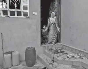  ??  ?? A woman reacts shortly after her son was fatally wounded last week by a mortar attack in front of her home in the Mawsil al Jadidah neighborho­od of Mosul, Iraq. Civilians in Mosul are fleeing the city amid coalition airstrikes.