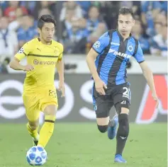  ??  ?? File photo of Dortmund’s Japanese midfielder Shinji Kagawa (left) controllin­g the ball as Club Brugge’s Belgian defender Dion Cools challenges during the UEFA Champions League Group C match at the Jan Breydel stadium in Bruges. — AFP photo