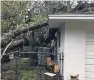  ??  ?? Jennifer Blodgett with husband Scott, and the house of a neighbour which took a direct hit from a falling tree during Hurricane Irma.