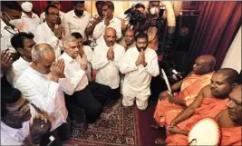  ?? PTI ?? Sri Lanka's new prime minister Ranil Wickremesi­nghe, third left, takes part in religious observance­s at a temple in Colombo, Sri Lanka