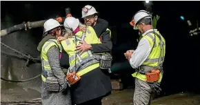  ??  ?? Anna Osborne, left, and Sonya Rockhouse embrace Minister Responsibl­e for the Pike River Re-Entry Andrew Little at the mine portal.