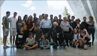  ?? PATTY NIEBERG — THE ASSOCIATED PRESS ?? Melpomeni Dina, center right, poses for a group photo during a reunion at the Yad Vashem Holocaust memorial in Jerusalem, Sunday. Dina, a 92-year-old Greek woman who rescued a Jewish family during the Holocaust has been reunited with two of the people she saved and dozens of their family members. Once a regular ritual, such reunions are quickly disappeari­ng due to the advanced age of the rescuers and survivors.