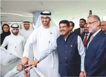  ??  ?? WAM Dr Sultan Bin Ahmad Sultan Al Jaber, Minister of State and Adnoc Group CEO, and Dharmendra Pradhan witnessed the loading of the first cargo of crude oil from Adnoc, destined for Indian Strategic Petroleum Reserves Ltd. A consortium of three Indian...