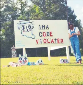  ?? CONTRIBUTE­D KYLE “BLACKCATTI­PS” BROOKS ?? Kyle “BlackCatTi­ps” Brooks is expected to appear in court May 23 to defend what he says is art in his yard. DeKalb County says they are signs and are violating code.