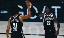  ?? ASHLEY LANDIS — THE ASSOCIATED POOL PHOTO ?? The Nets’ Jarrett Allen (31) and Caris LeVert celebrate after a play during Brooklyn’s victory over Sacramento on Friday.