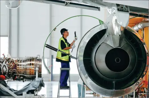  ?? PROVIDED TO CHINA DAILY ?? An employee checks an engine at the A320 family final assembly line of the Airbus factory in Tianjin.