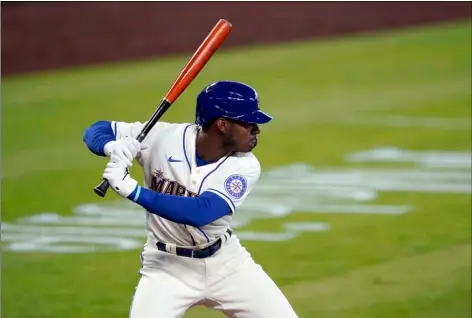  ?? AP FILE PHOTO/TED S. WARREN ?? In this Aug. 23 file photo, Seattle Mariners’ Kyle Lewis begins his swing on a solo home run against the Texas Rangers during the first inning of a baseball game in Seattle.