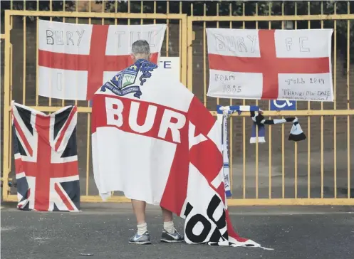  ??  ?? 0 A Bury fan at the gates of Gigg Lane yesterday as news emerged that a proposed takeover by C&N Sporting Risk had fallen through.